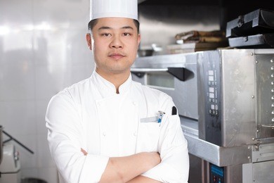 young chinese man chef in modern kitchen