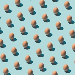 pattern made of eggs on pastel blue background. minimal food concept.