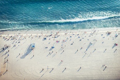 santa monica beach, drone view - people sunbathing on the beach and swimming in the ocean