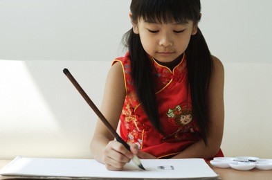 young girl practicing calligraphy