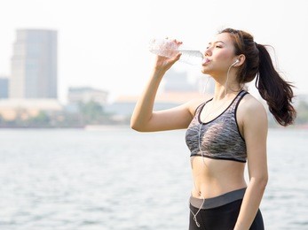 woman fitness outdoor concept, young asian beautiful woman drinking water during workout, running, jogging, yoga at outdoor park, fresh, relax, happy feeling