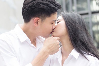 man and woman kissing, asian lover making love by kissing together (love couple or pre-wedding concept)