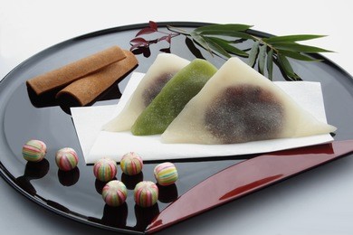 various type of sweets (local delicacy in kyoto, japan); cinnamon-seasoned steamed dough made from ground rice, baked cinnamon cookie and candy/ japanese kyoto sweets souvenir on lacquered tray