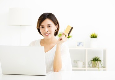 young woman shopping online and paying with  credit card