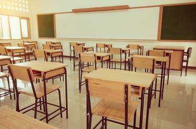 school classroom with desks chair wood, sand blackboard in high school thailand, vintage tone education concept