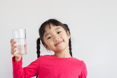 asian child drink water 