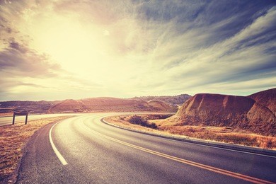 vintage toned scenic desert highway at sunset, travel concept, usa.