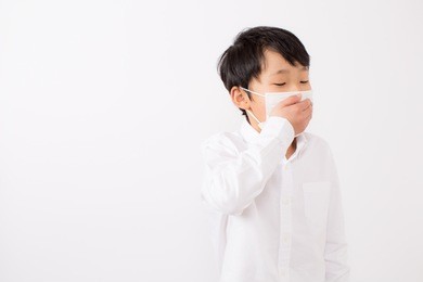 boy who caught a cold. he is wearing a mask