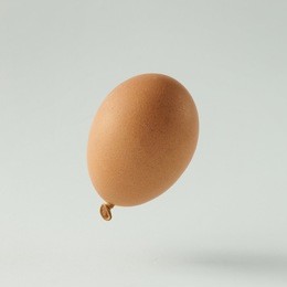 egg balloon on bright white background. minimal creative concept. flat lay.