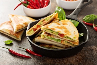 vegan quesadillas with avocado and red pepper served with tomato salsa