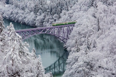 japan mountain and snow with local train in winter season at mishima town , fukushima prefecture.
