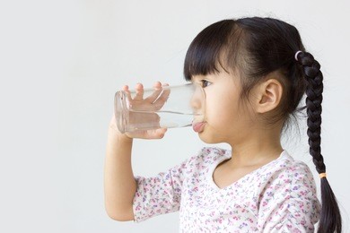 asian kid drinking water. 