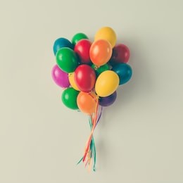colorful bunch of easter egg balloons on bright white background. minimal creative concept. flat lay.