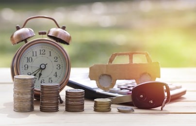 pile of money coins and key, concept in insurance,loan,finance and buying car background