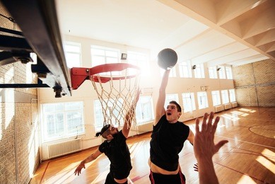 photo of basketball players playing basketball on the court.