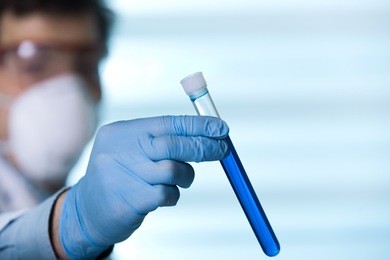 scientist in lab holding a tube test for analysis / researcher in the laboratory holding test tube