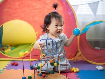 baby girl playing toy in camping