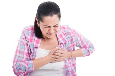 woman having severe chest pain as heart attack and illness concept isolated on white background