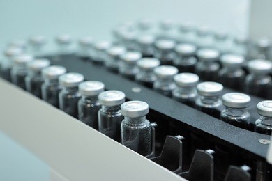 sterile bottles and ampoules on the dispensing line.sealed ampoules with medicine.sterile capsules for injection. bottles on the bottling line of the pharmaceutical plant.