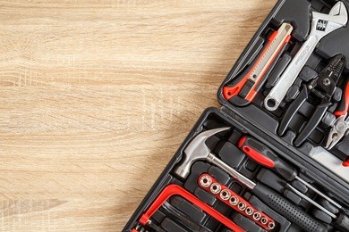 new square black tool box on wooden texture background. top view
