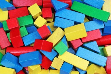 wooden toy background. red, blue, yellow green wooden toy blocks on white background. wood block texture pattern.