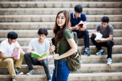 group of happy teen high school students outdoors