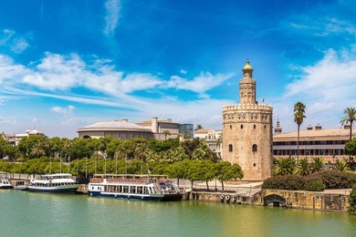 golden tower (torre del oro) along the guadalquivir river in sevilla in a beautiful summer day, spain