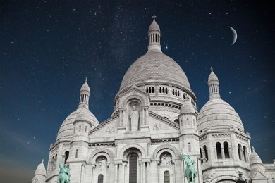 montmartre paris. basilica of the sacred heart of jesus. night shining moon and stars.