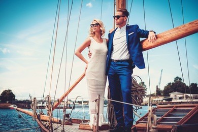 stylish wealthy couple on a luxury yacht.