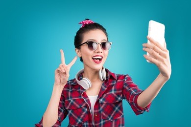 smiling lovely active asian girl taking selfie photo.