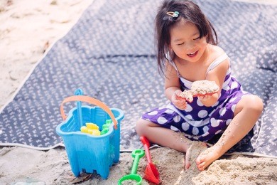 little asian girl playing on the beach.vacation and relax concept.