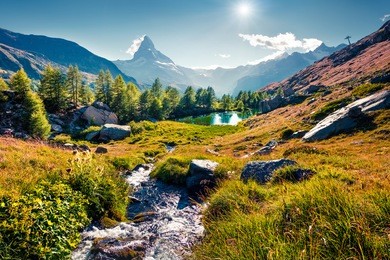 colorful summer sunrise on the grindjisee lake. reflection of matterhorn (monte cervino, mont cervin) peak in the watter surface. beautiful outdoor scene in swiss alps, zermatt location, switzerland.