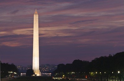 washington monument at sunset. focus on monument against purple and pink sky.