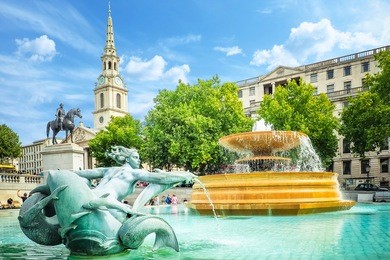 view of the fountains in the trafalgar square on a bright summer day