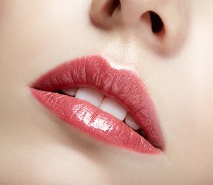closeup shot of female pink mouth lips and white teeth