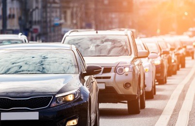 close-up of the lane of cars in traffic jam against the sun