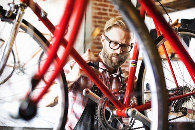 a man working in a bicycle repair shop