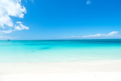 beautiful marine view on caribbean sea coast line with clean wavy surf ocean water on sandy beach at sunny day as natural background with blue sky, st. john, antigua