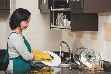 senior vietnamese housewife doing housework