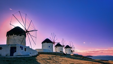 traditional windmills, the symbol of mykonos at sunset, greece