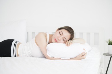 young beautiful asian woman sleeping on white bed happy as background beauty and healthy concept.