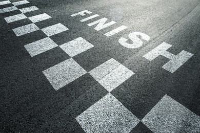 sunny finish line pattern racing background on the asphalt floor.