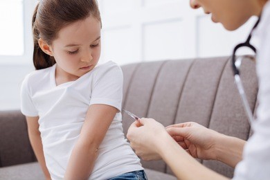 brave young girl receiving an injection