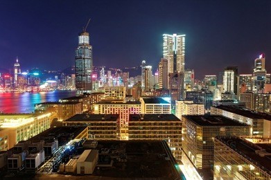 night scenery of hong kong, viewed from tsim sha tsui area in kowloon, with city skyline of crowded skyscrapers & colorful city lights along victoria harbour ~ beautiful cityscape of hongkong at dusk