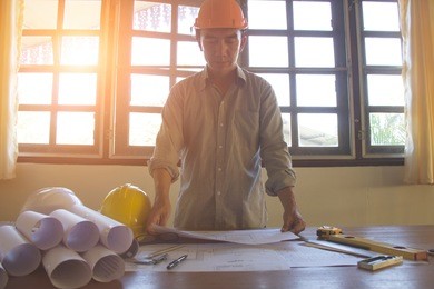 engineer and architect planing and discuss at construction site with blueprint