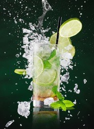 fresh mojito drink with liquid splash and crushed ice in freeze motion, close-up.
