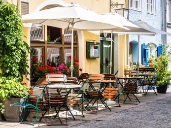table and chairs at a sidewalk cafe
