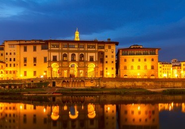 embankment of arno with world famous uffizi museum at night, florence, italy