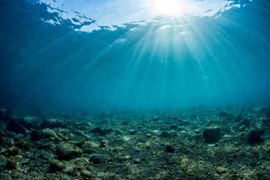 rays of sunlight shining into sea, underwater view
