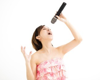 beautiful young woman singing karaoke isolated on white